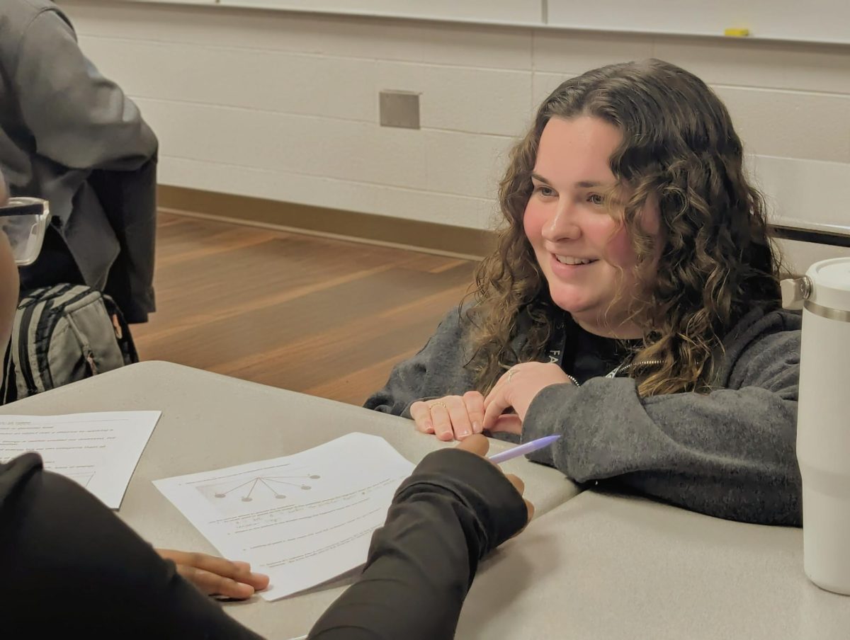 Mrs. Williams helping a student with their worksheet