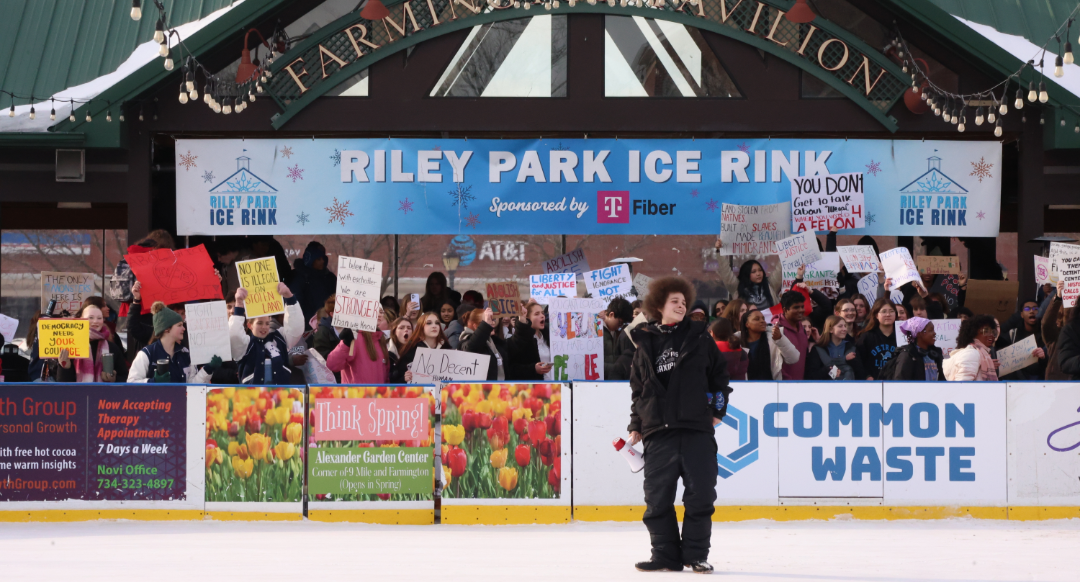 Axel, Organizer of the protest and founder of Farmington Hills Union, stands on the ice rink to speak to demonstrators.