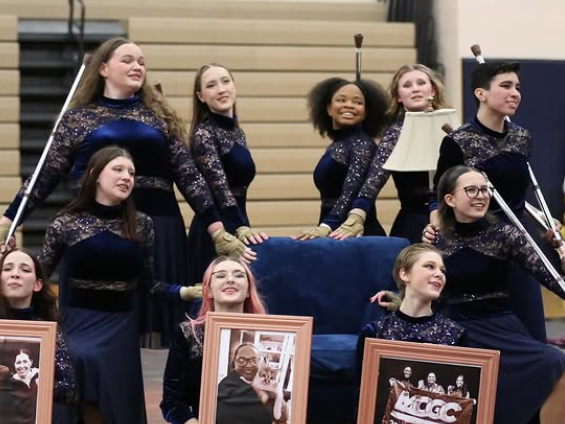 A group photo of Winter Guard posing after a performance.