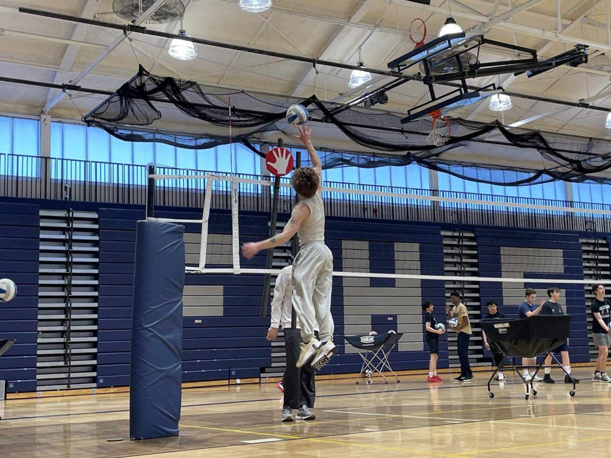 Player practices getting the ball around a stand-in middle blocker.