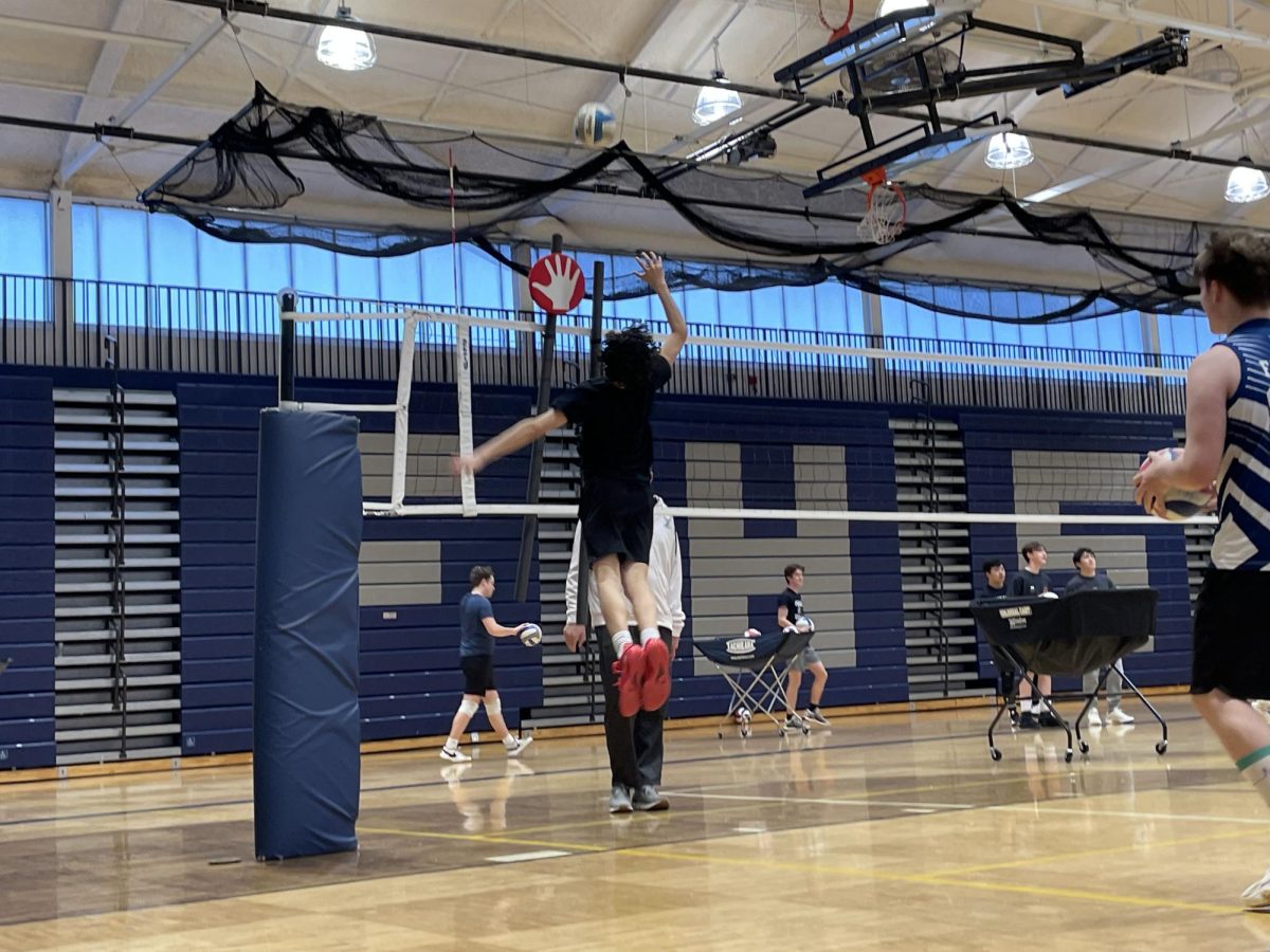 Player practices getting the ball around a stand-in middle blocker.