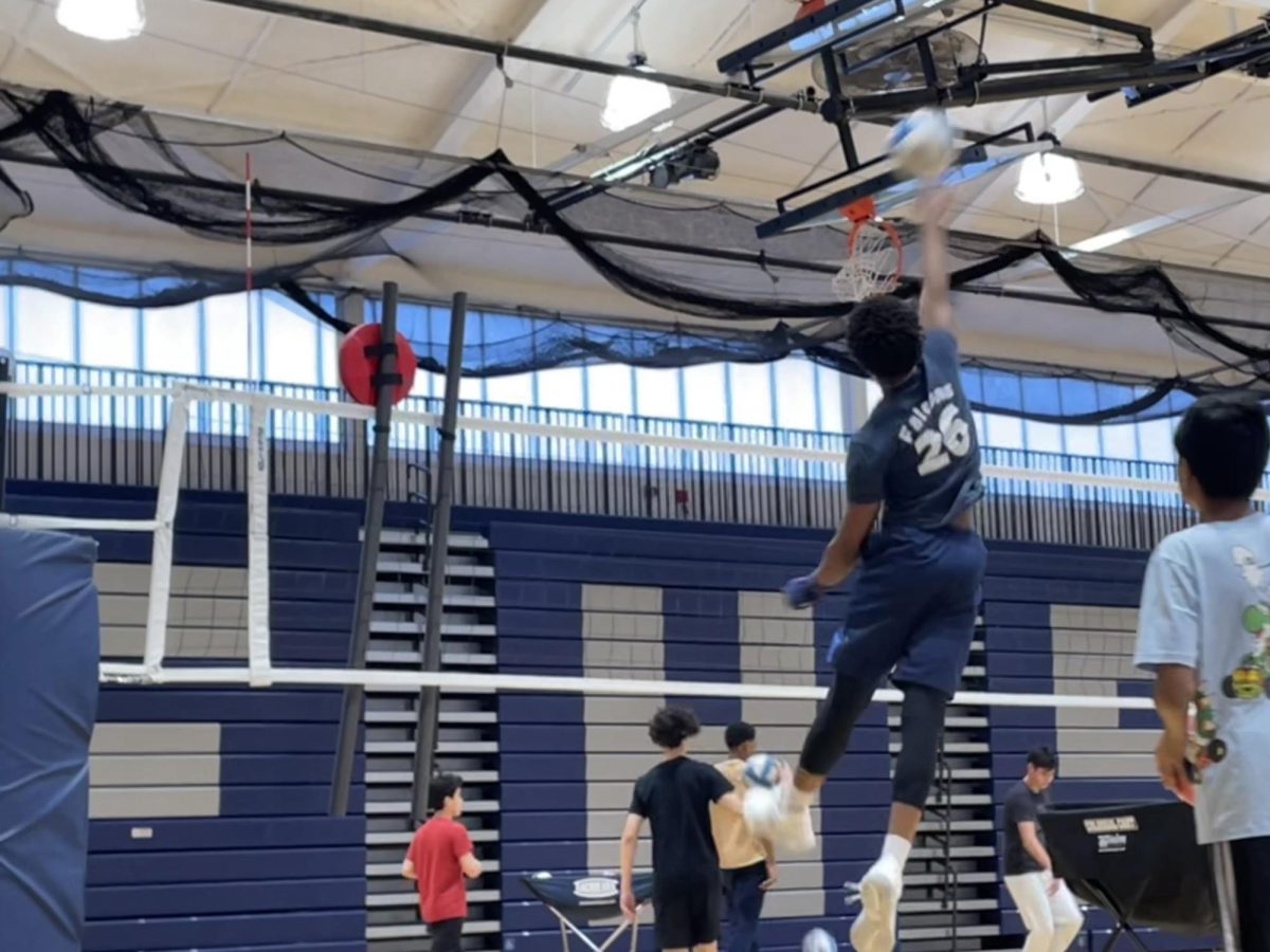 Player spikes the ball over the net.