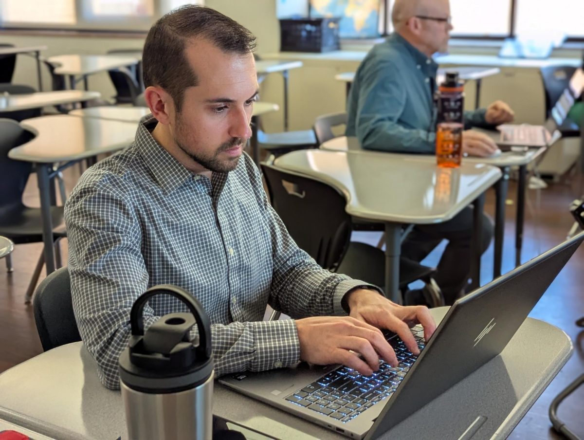 Mr. Trotta, working on his laptop